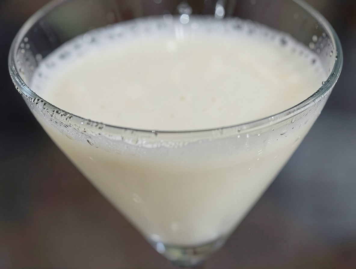 Close-up of the creamy Foxy Lady cocktail with a thin foam layer.