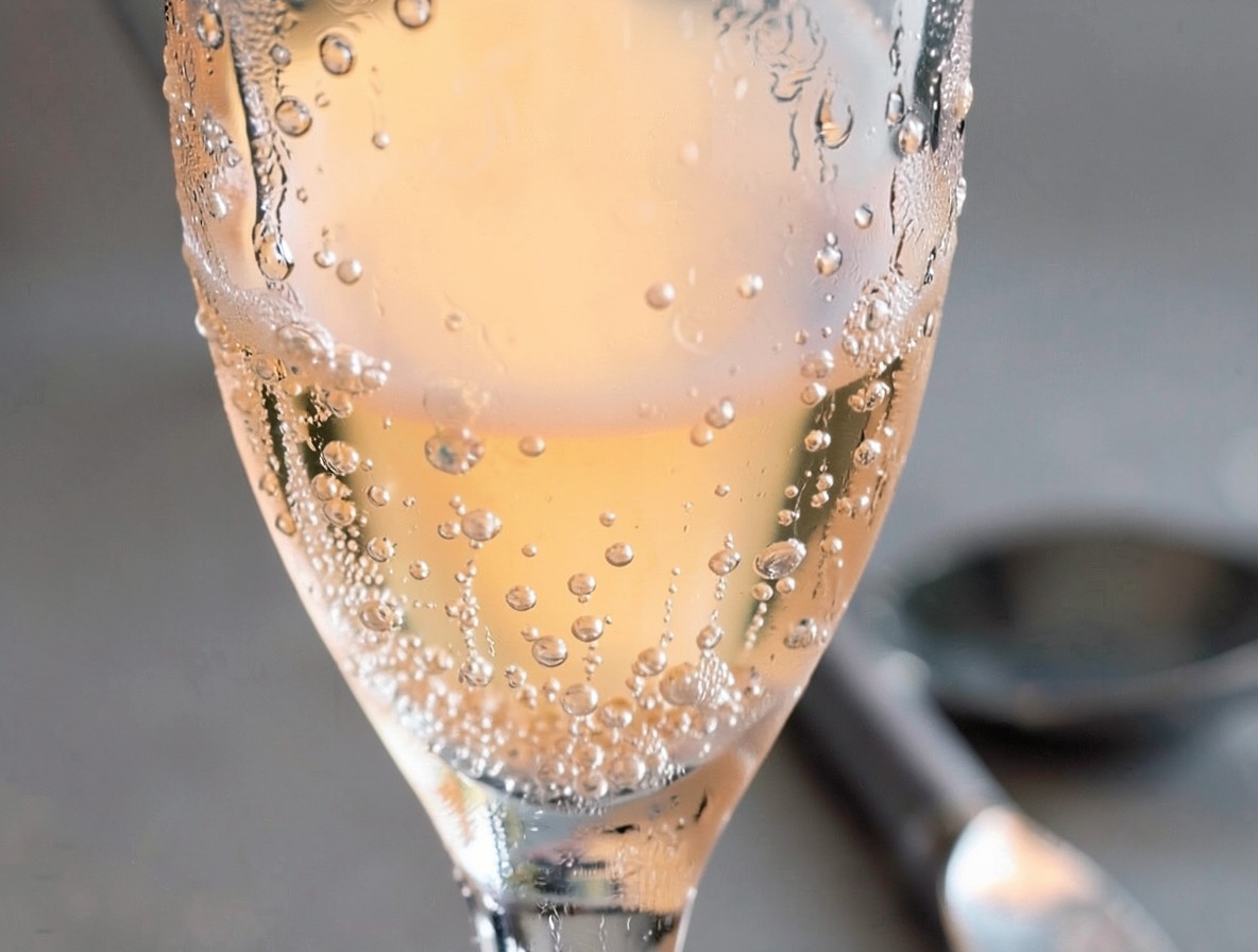 Close-up of a finished mimosa with bubbles and condensation